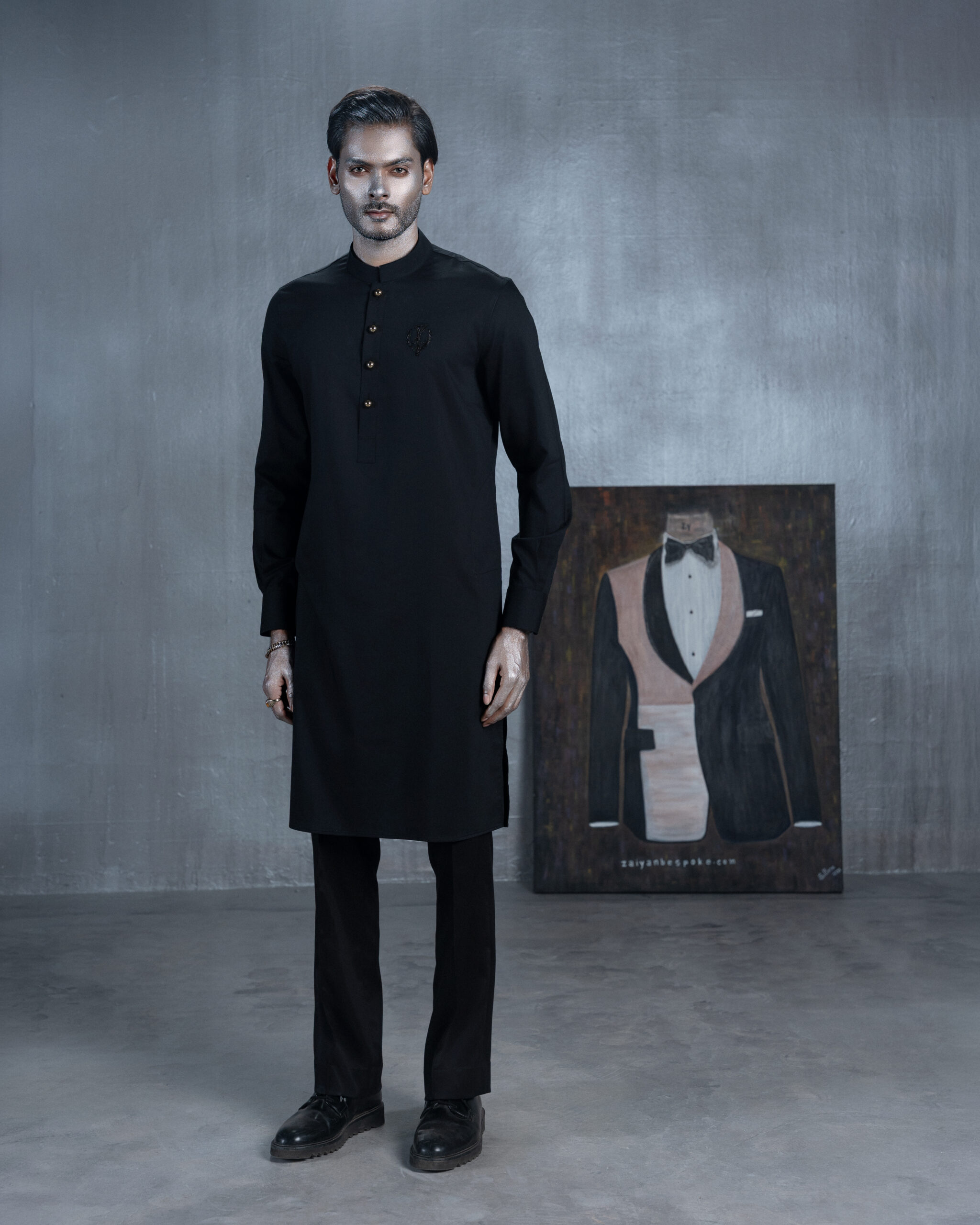 Black bespoke Panjabi with metallic buttons and embroidered chest emblem by ZaiYan Bespoke