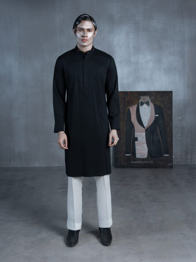 Black bespoke Panjabi with embroidered band collar, black threadwork and multicolour paisley-pattern cuffs by ZaiYan Bespoke.