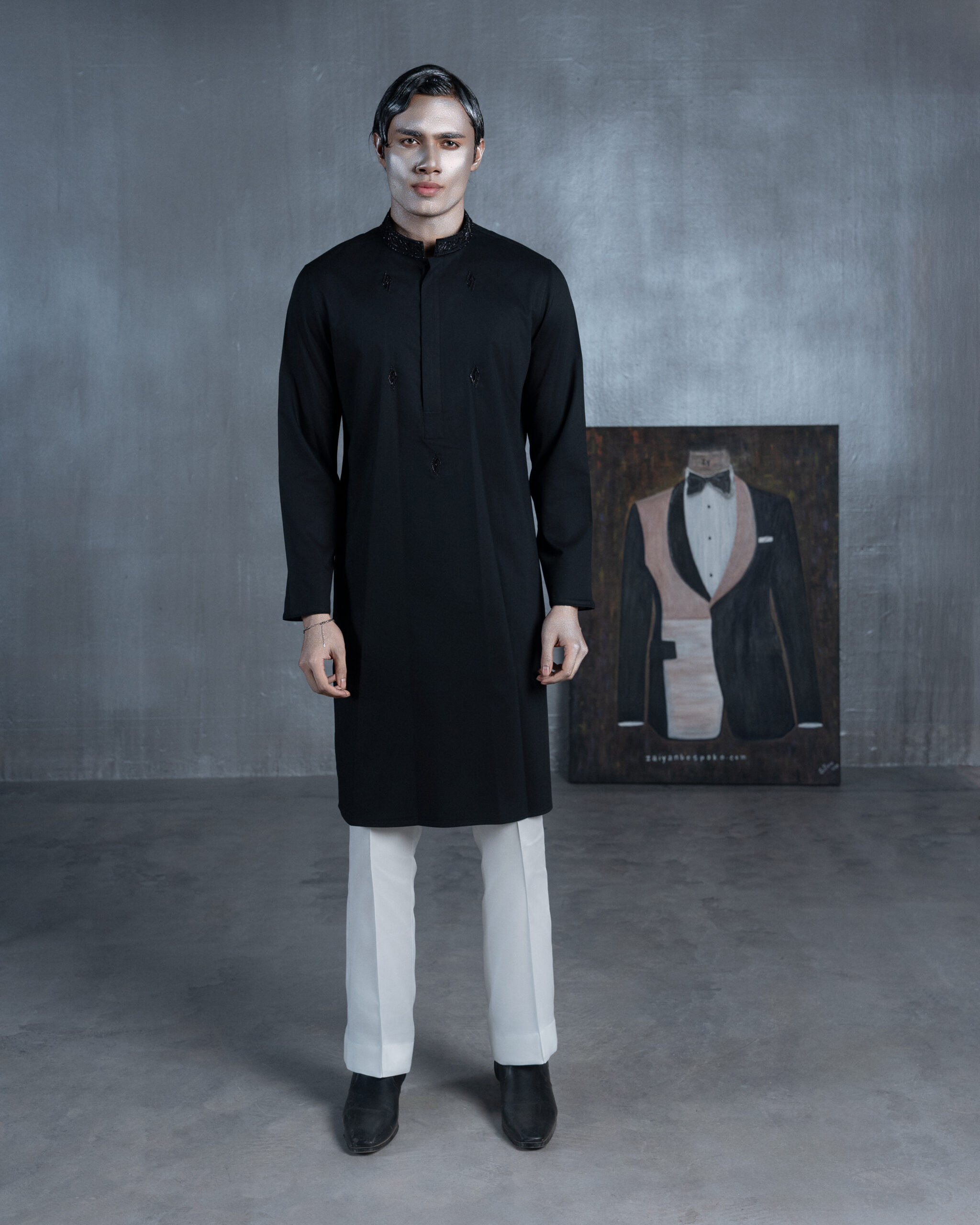 Black bespoke Panjabi with embroidered band collar, black threadwork and multicolour paisley-pattern cuffs by ZaiYan Bespoke.