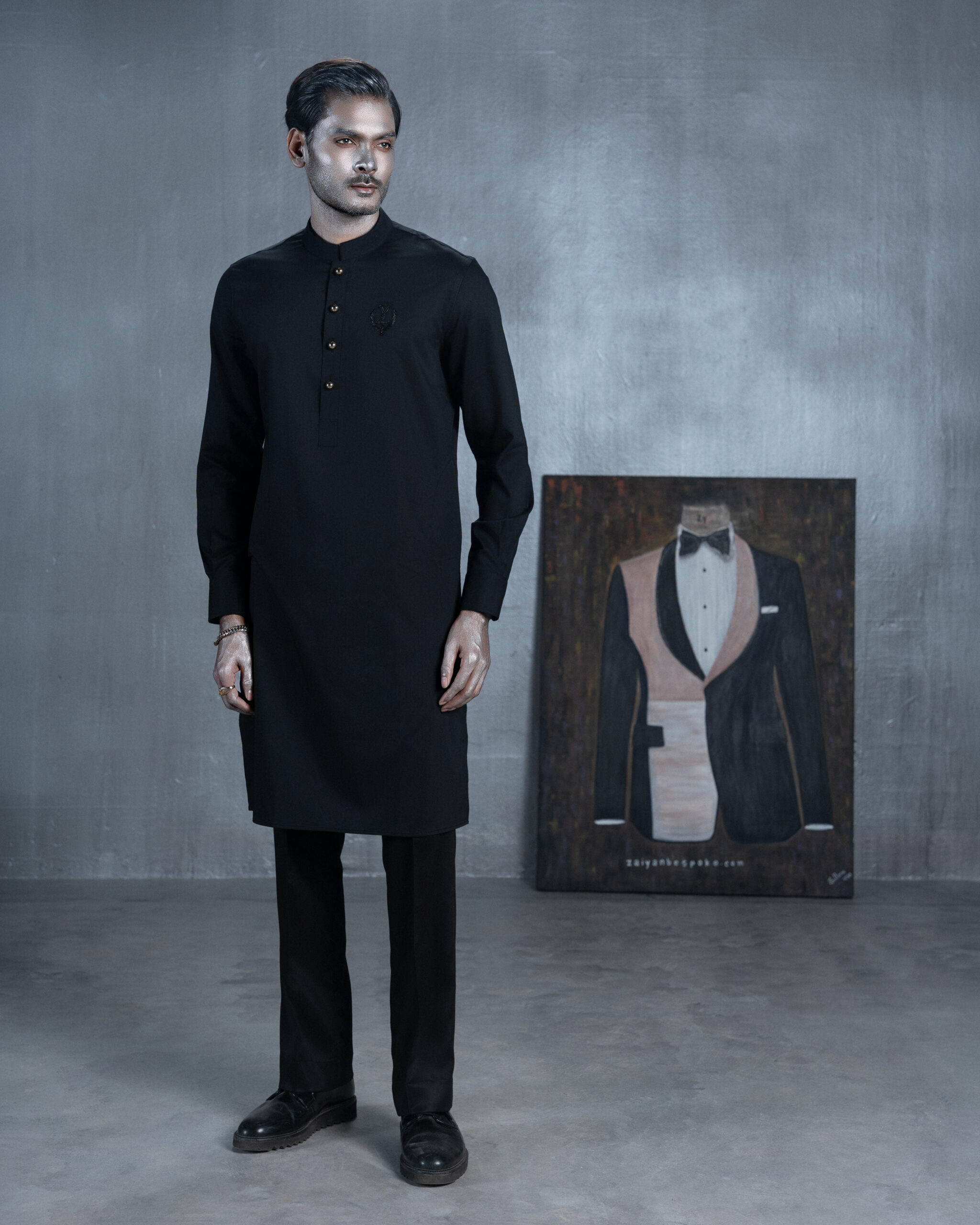 Black bespoke Panjabi with metallic buttons and embroidered chest emblem by ZaiYan Bespoke